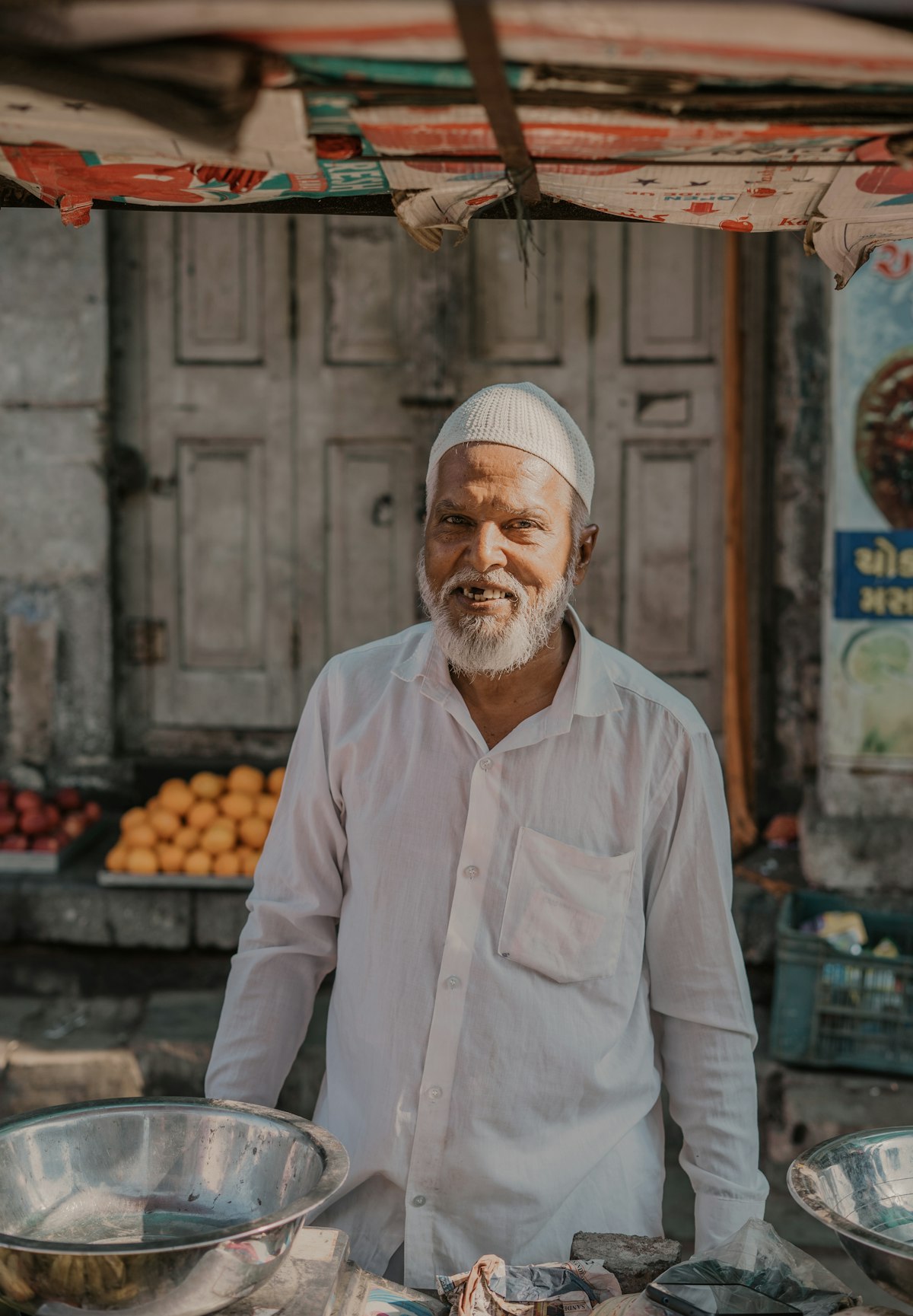 Shopkeeper standing at his fruit stall