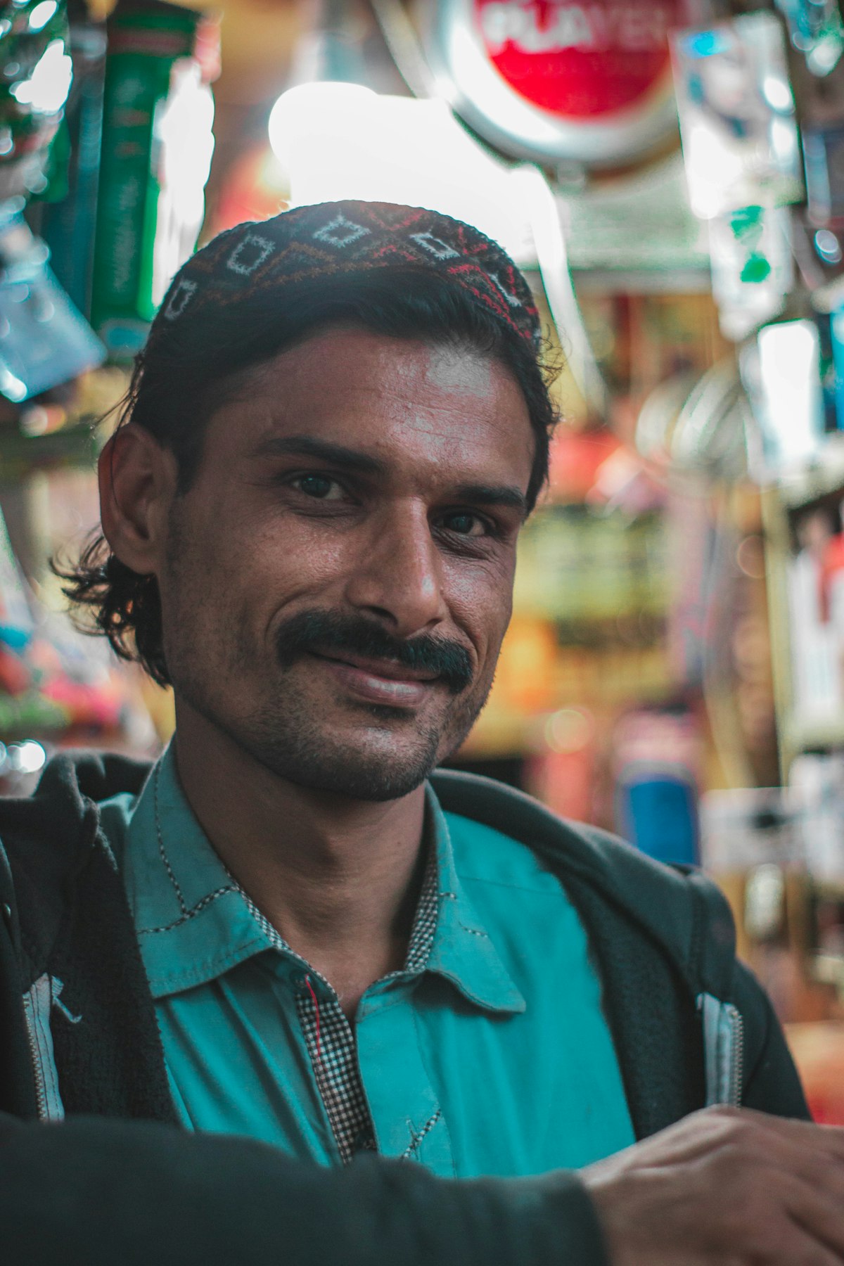 Shopkeeper smiling in his shop